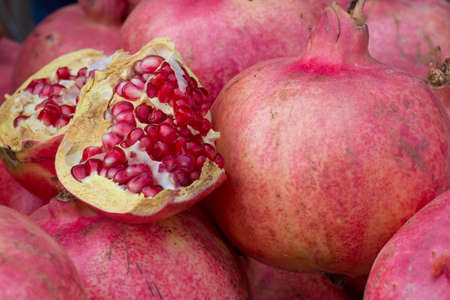 Pile of pomegranates cut open on a marketの写真素材
