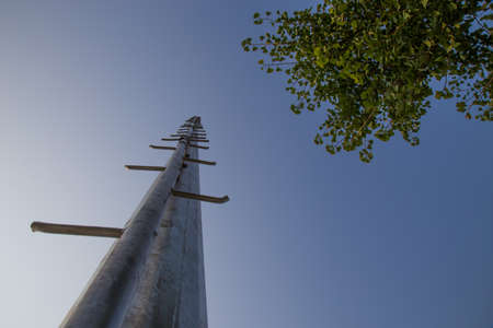 Metal pole with steps leading into the skyの写真素材