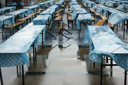 Ruined beer festival due to rain with wet tables and chairsのeditorial素材