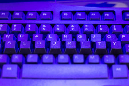 Keyboard with the keys security elevated in blue lightの写真素材