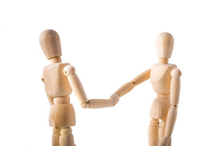 Two puppets shaking hands on white backgroundの写真素材