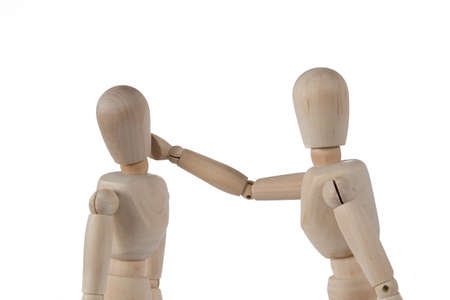 Puppet slaps another puppet in the face on white backgroundの写真素材