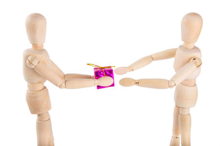 Wooden puppet gives a purple gift to another puppetの写真素材