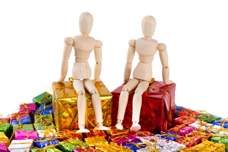 Wooden kids sitting on two big parcels on white backgroundの写真素材