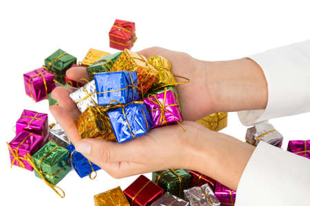 Woman's hands holding a lot of little christmas parcelsの写真素材