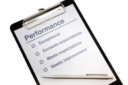 Performance evaluation paper with pen and tick marks on clipboardの写真素材