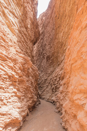 Narrow path through steep red mountain with no escape