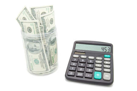 Money jar with dollar and calculator on whiteの写真素材