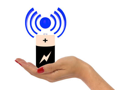 Woman's hand with red fingernails holding wireless charging iconの写真素材