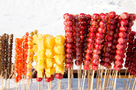 Frozen sugar coated fruits with icy background in winterの写真素材