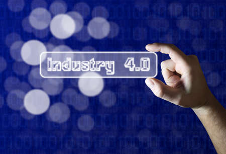Hand holding industry 4.0 sign on blue background with bokehの写真素材