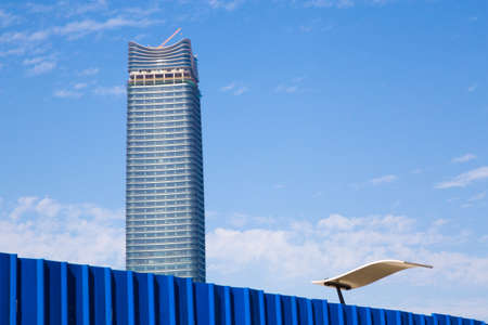 Shanghai,China - 2016: Finalizing construction of a new Shanghai skyscraper with a yellow crane on top on a crystal clear sunny day without pollutionのeditorial素材