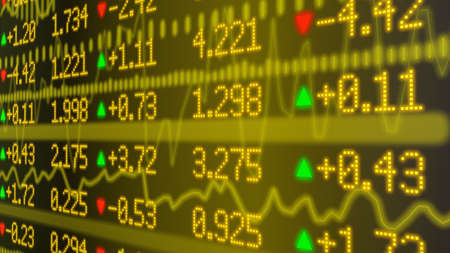 Stock market ticker wall in yellow with various numbers and graphsの写真素材