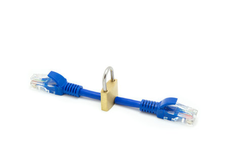 Secure connection concept with a padlock standing in between two cut network cables