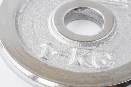 Metal round weight of one kg closeup in silverの写真素材