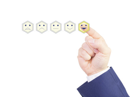 Hand of businessman with blue suit pushing smiling hexagon smiley success performance evaluation conceptの写真素材