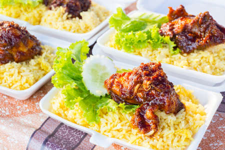 Fried satay chicken with rice and salad on a food market in Malaysiaの写真素材