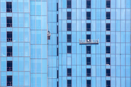 Office building construction with many missing glasses and a cable carのeditorial素材