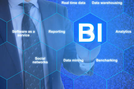 The future of business intelligence presented by a businessman clicking on BI with surrounding hexagon fieldsの写真素材