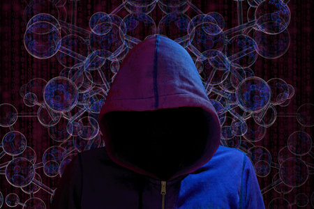 Hacker with dark hoody in red and blue light in front of a spherical network darknet concept