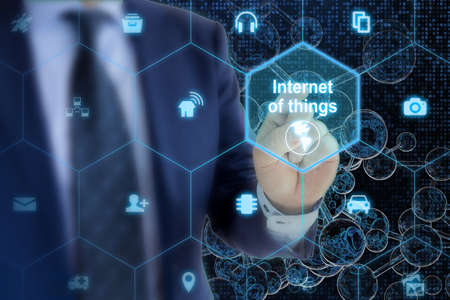 IT expert touches hexagon grid with IOT symbols on a digital letter glass spheres network backgroundの写真素材
