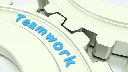 Two connected gears in silver on a shiny floor with the word teamwork engraved 3D illustrationの写真素材