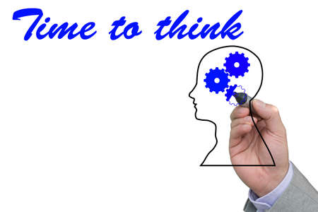 Hand of a businessman filling out a gear outline with a blue pen and the words time to think isolated on whiteの写真素材