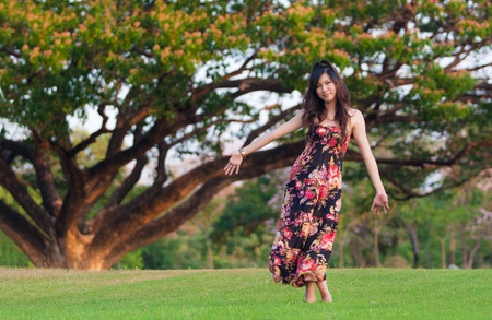 Beautiful young asia  woman in color dress posing outdoorの写真素材