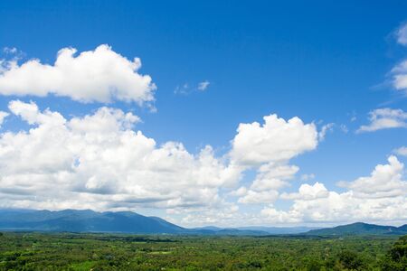 Mountains with forest and blue sky with cloudsの写真素材