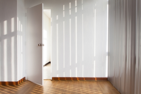 Door open in a room with sun shadeの写真素材