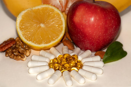 Different types of vitamins - fruits, nuts and pills. A freshness and a juiciness - still life of a healthy lifestyleの写真素材
