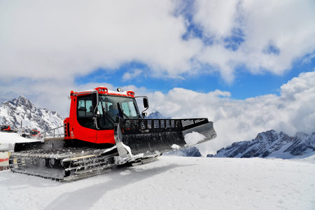 A driver driving a crawler loader to work on a snow field, Zugspitzeのeditorial素材