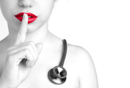 Nurse girl making silence with her finger Nurse girl making silence with her finger