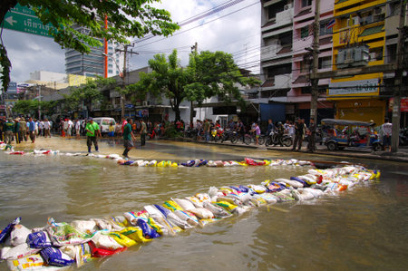 BANGKOK - OCT 29: Unidentified residents of Bangkok's Dusit district make their way through flooded streets after the Chao Phraya River bursts its banks on Oct 29, 2011 in Bangkok, Thailand.のeditorial素材