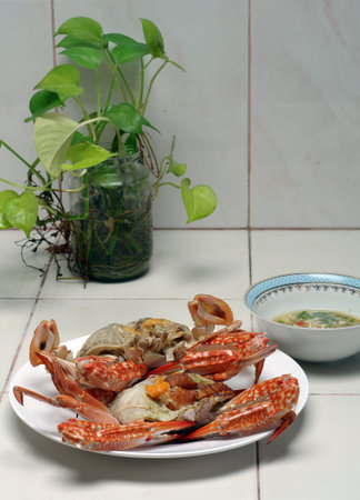 Steamed red crabs on a white plateの写真素材