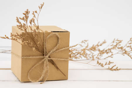 Gift box wrapped in recycled paper with grass.の写真素材