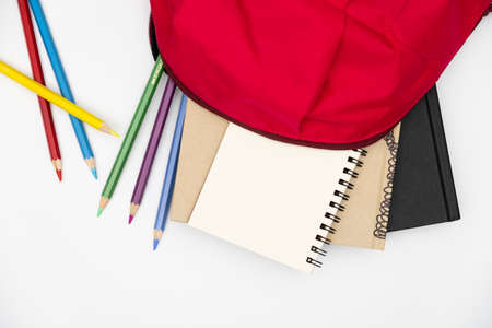 Top view- backpack and school stationery on white background.の写真素材
