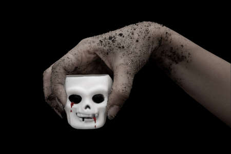zombie Halloween hand and white skull isolate on black bacground.の写真素材