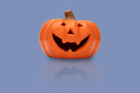 Halloween pumpkin on blue background. Halloween idea concept.の写真素材