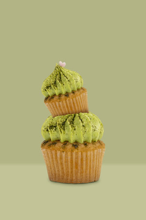 Green tea cupcake on green background, idea minimal concept for new year and christmas holliday.