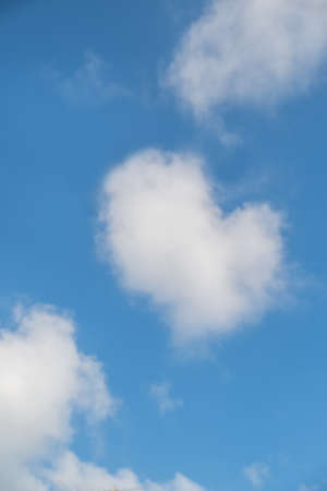blue sky with hearts shape in clouds.の写真素材