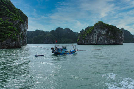 Fishing boat in Halong Bay close to the city of Cat Baの写真素材