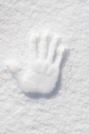 The palm of your hand is imprinted in the snow.の写真素材