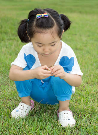 The little girl on the grass.の写真素材