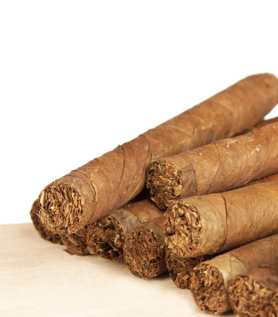 Heap of cigars on old wooden surface.の写真素材