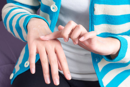 Close-up woman rub hand cream