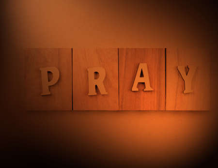 pray word in cutting wooden, isolated on whiteの写真素材