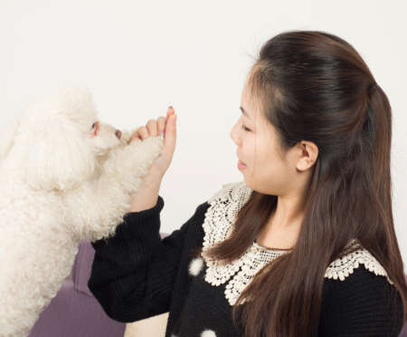 The girls and Poodle intimate together.の写真素材