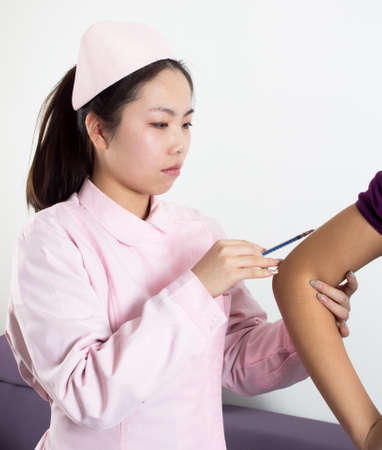 Close-up nurses are vaccinated for patients.の写真素材
