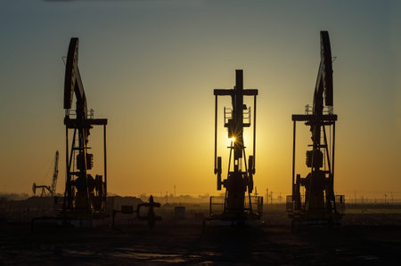  Work of oil pump jack on a oil field. Oil and gas industry. の写真素材